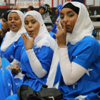 Somali girls wearing traditional Somali flag dresses at Heritage Week celebration in Brooks