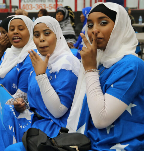 Somali girls wearing traditional Somali flag dresses at Heritage Week celebration in Brooks