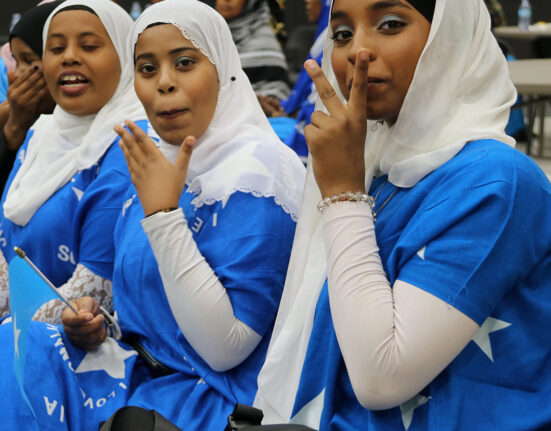 Somali girls wearing traditional Somali flag dresses at Heritage Week celebration in Brooks
