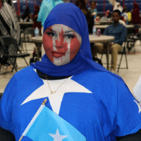 Somali girl wearing Somali flag clothing with Canadian flag painted on her face