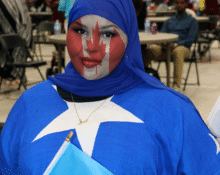 Somali girl wearing Somali flag clothing with Canadian flag painted on her face