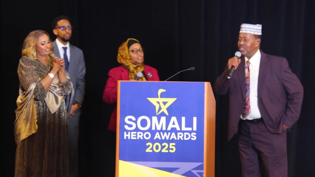 Salad Darbi receives an award on stage during the Somali Hero Awards ceremony in Minnesota